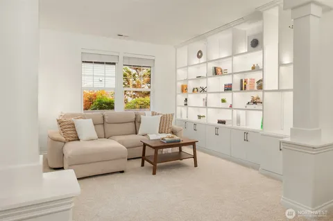 a living room with furniture a window and a table