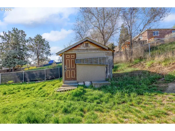a pathway of a house with a yard