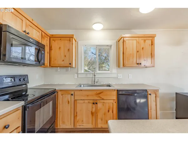 a kitchen with stainless steel appliances granite countertop a sink stove and cabinets