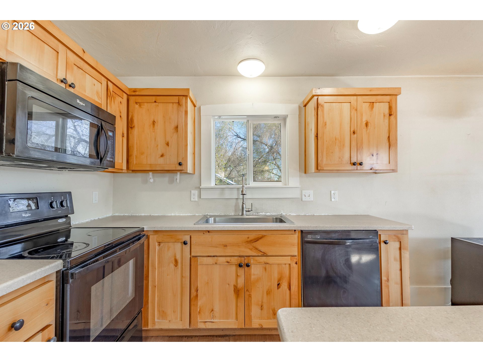 342 Southeast 7th Street Madras, OR 97741 - Photo 4 of 22 a kitchen with stainless steel appliances granite countertop a sink stove and cabinets