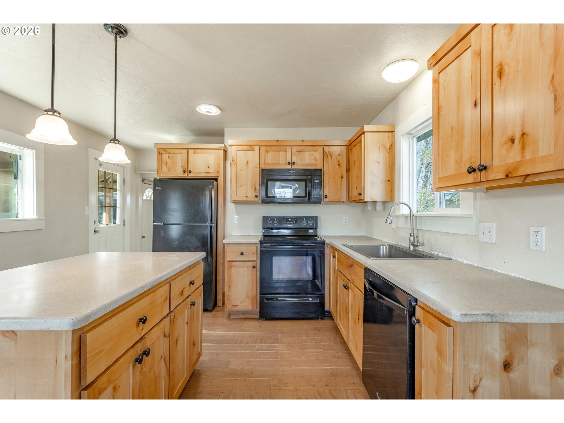 342 Southeast 7th Street Madras, OR 97741 - Photo 5 of 22 a kitchen with stainless steel appliances granite countertop a sink a stove and a refrigerator