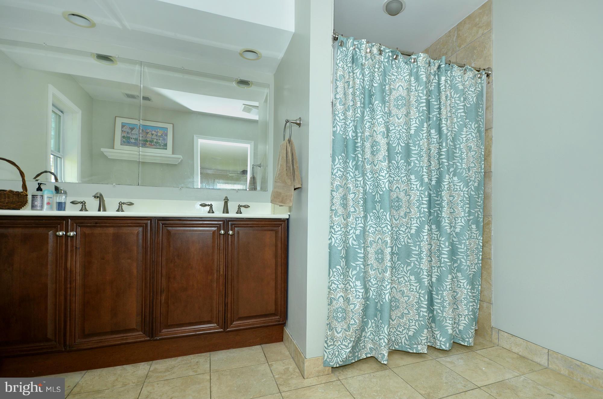 8010 Rider Avenue Baltimore, MD 21204 - Photo 14 of 29 a bathroom with a double vanity sink and a mirror