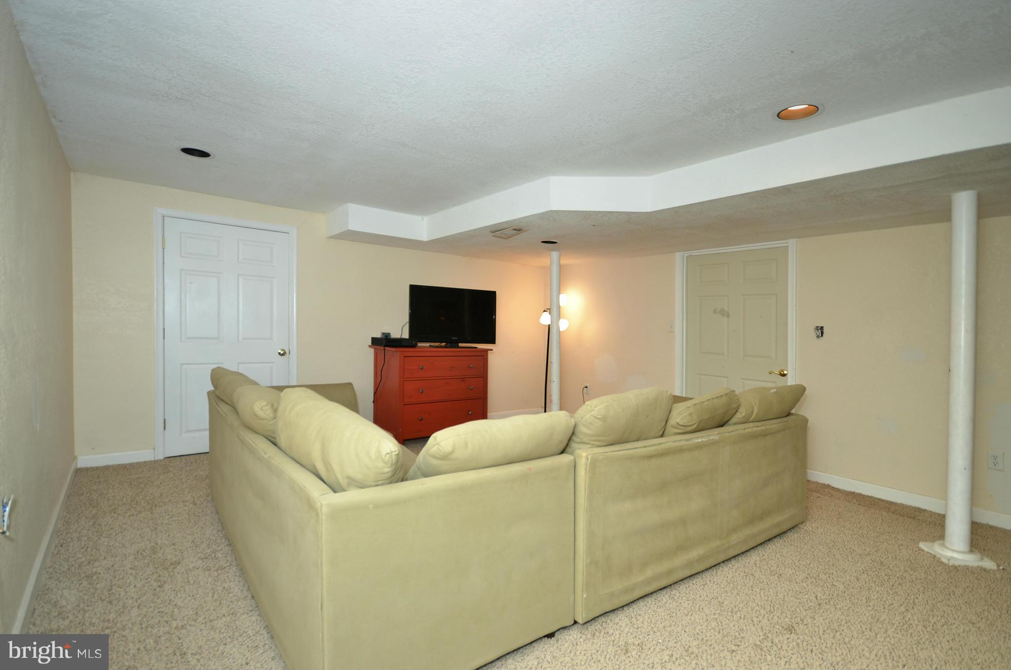 8010 Rider Avenue Baltimore, MD 21204 - Photo 23 of 29 a living room with furniture and a flat screen tv