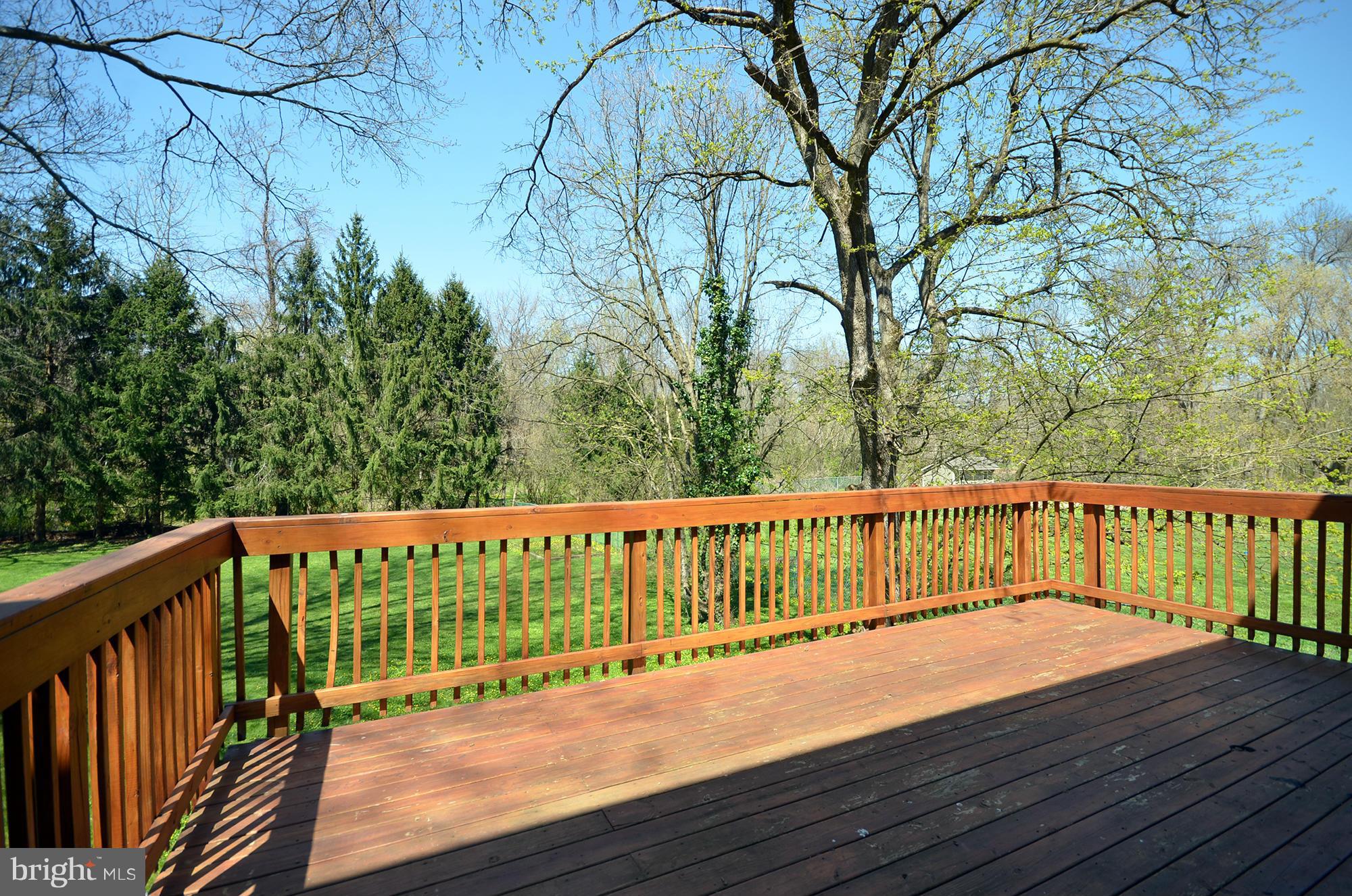 8010 Rider Avenue Baltimore, MD 21204 - Photo 25 of 29 a balcony with wooden floor and trees