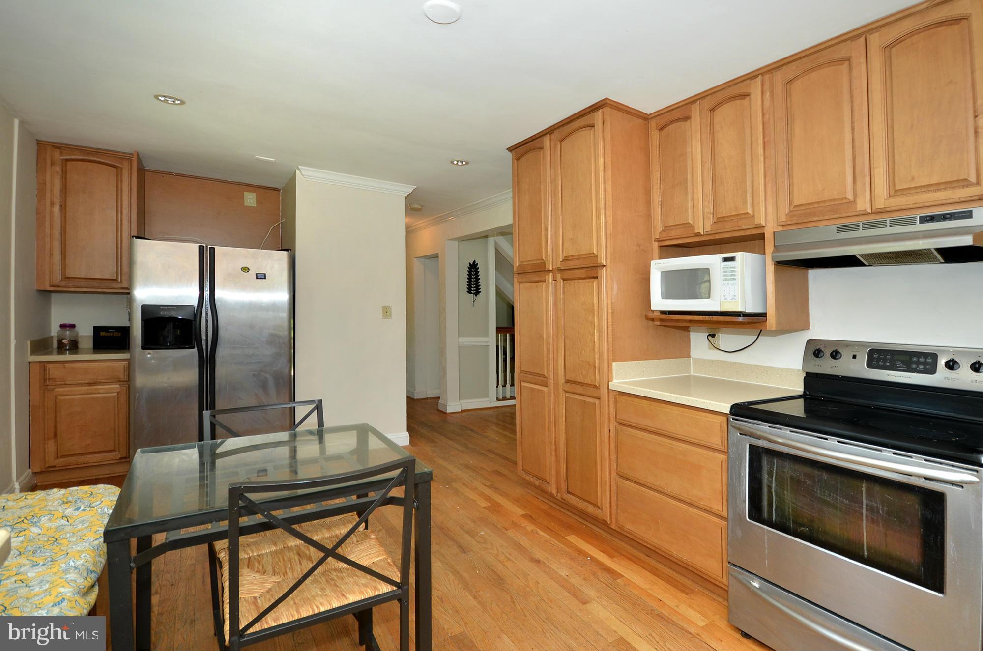 8010 Rider Avenue Baltimore, MD 21204 - Photo 4 of 29 a kitchen with stainless steel appliances granite countertop a stove a refrigerator and a microwave