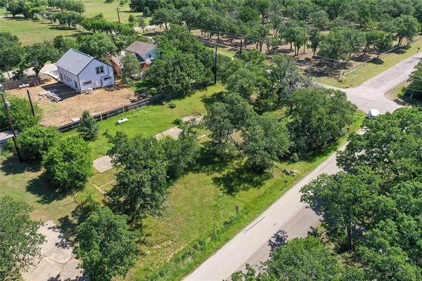 an aerial view of a house with a yard and lake view