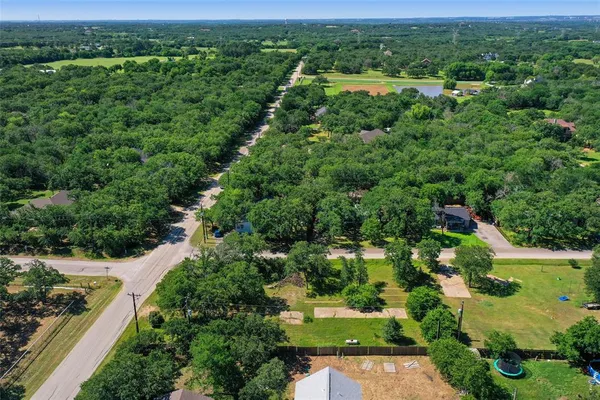 an aerial view of a house with yard