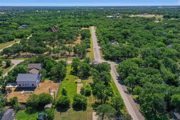 an aerial view of a houses with a yard
