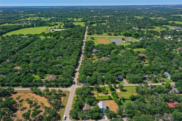 an aerial view of a houses with a yard