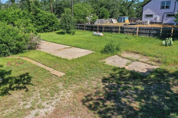 a view of a backyard with sitting area