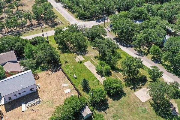 an aerial view of a house with a yard and lake view