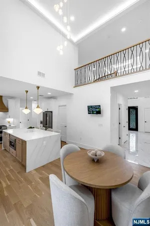 a living room with furniture and a view of kitchen