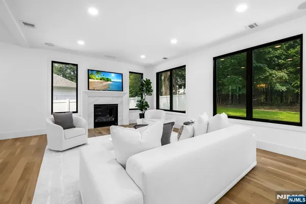 a living room with furniture and large windows