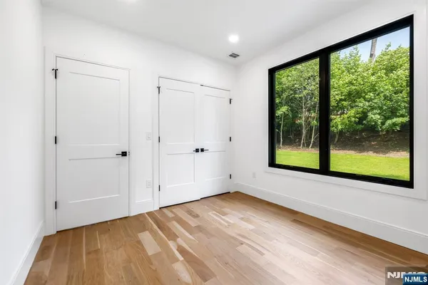 a living room with furniture and large windows