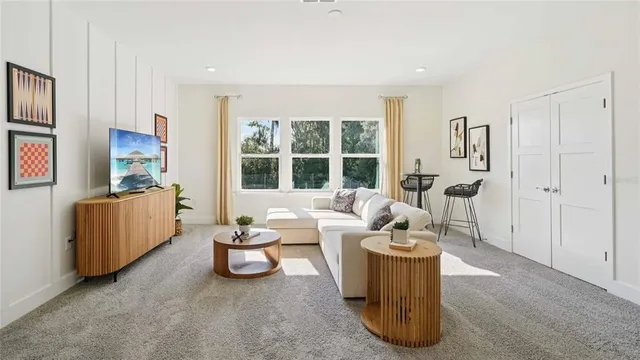 a bedroom with a bed and large windows