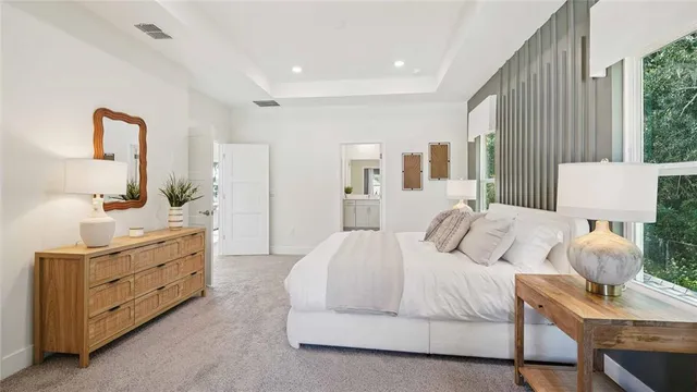 a spacious bedroom with a bed and a couch