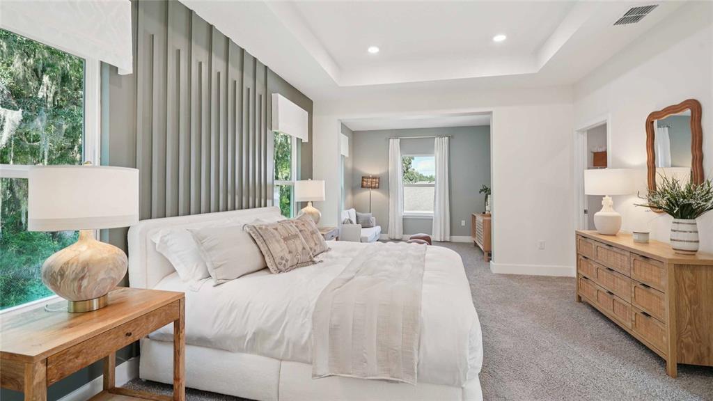 11269 Duckling Way Weeki Wachee, FL 34613 - Photo 22 of 33 a spacious bedroom with a bed and a couch