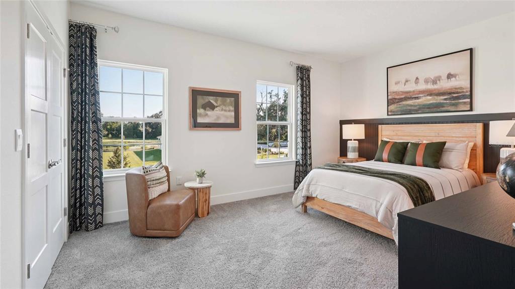 11269 Duckling Way Weeki Wachee, FL 34613 - Photo 27 of 33 a bedroom with a bed and a painting on the wall