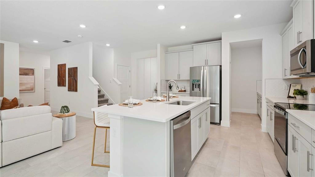 11269 Duckling Way Weeki Wachee, FL 34613 - Photo 9 of 33 a kitchen that has a sink a stove and a refrigerator