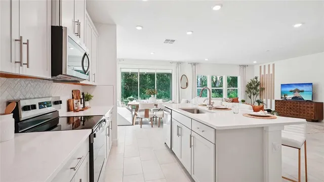 a kitchen with stainless steel appliances kitchen island granite countertop a sink and cabinets