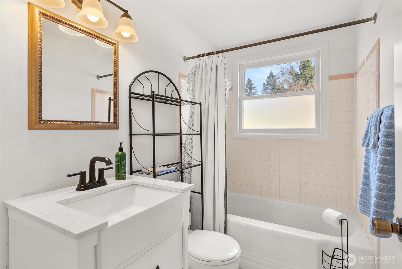 4532 14th Way Southeast Lacey, WA 98503 - Photo 14 of 22 a bathroom with a toilet sink vanity tub and mirror