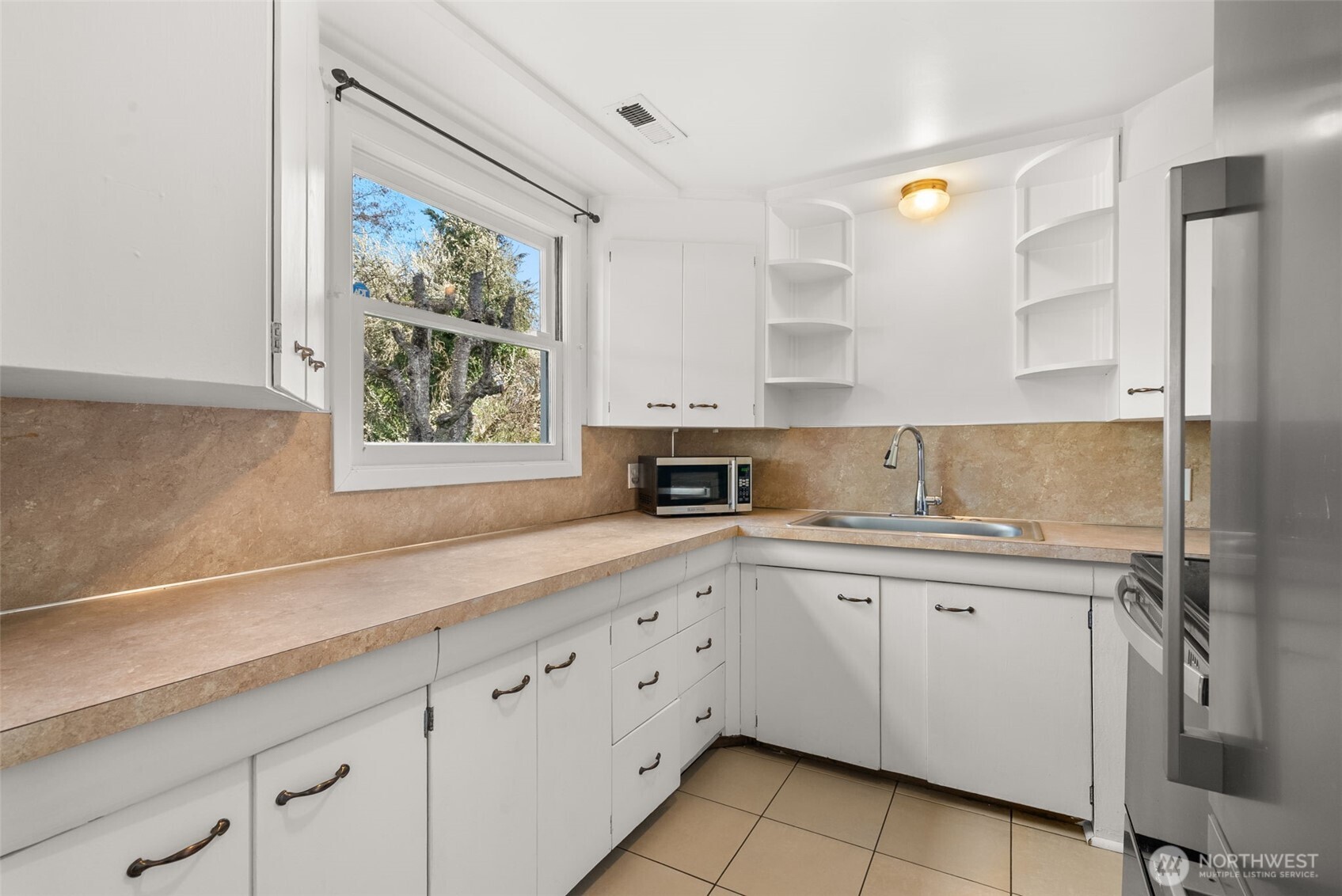 4532 14th Way Southeast Lacey, WA 98503 - Photo 7 of 22 a kitchen with a sink window and cabinets