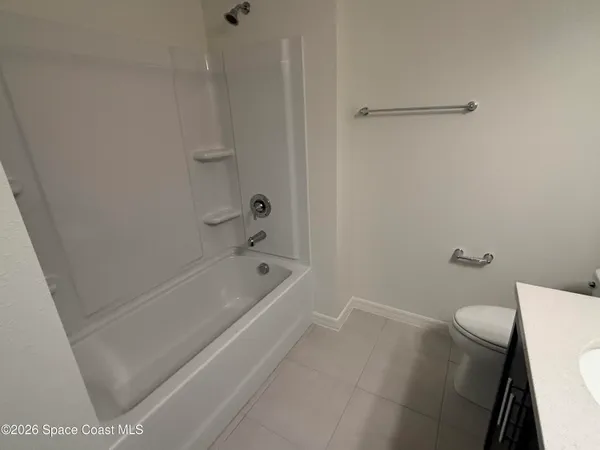 a bath room with a toilet and a bath tub