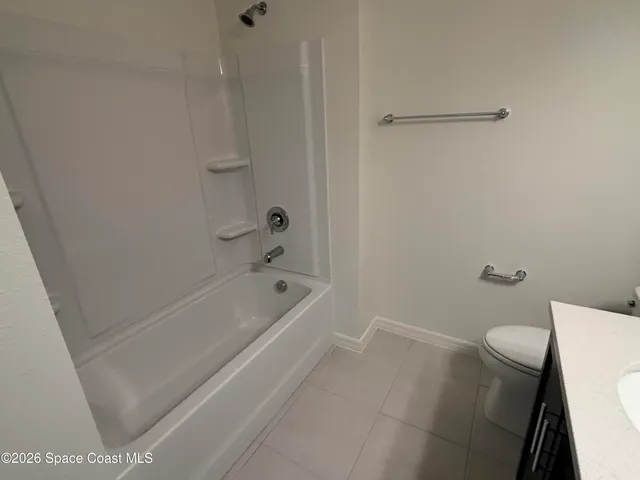 a bath room with a toilet and a bath tub