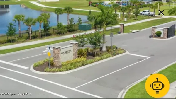a view of a swimming pool with a yard and plants