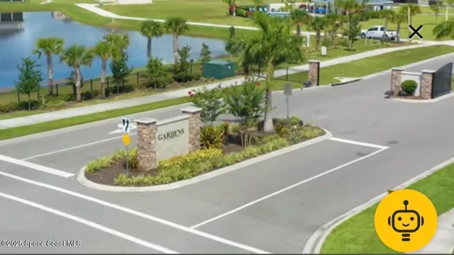a view of a swimming pool with a yard and plants