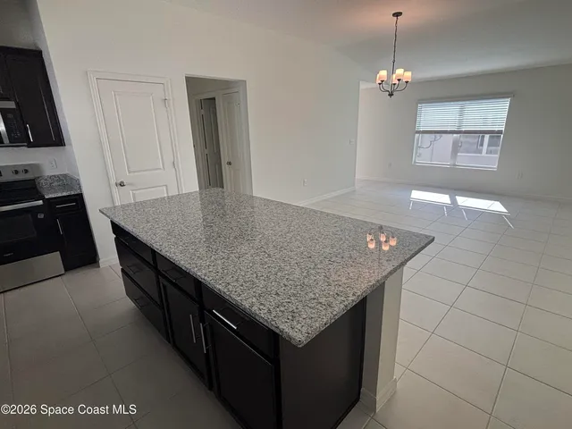 an open kitchen with granite countertop a sink and dishwasher