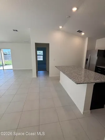 a view of kitchen cabinets and living room