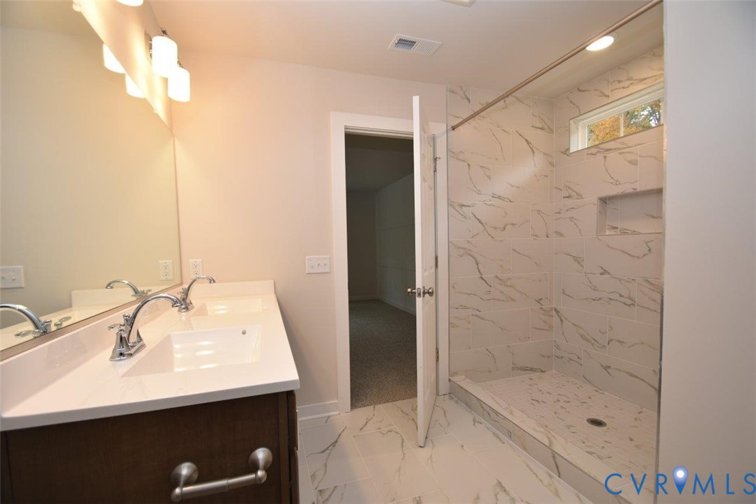 375 Amick Road Louisa, VA 23093 - Photo 25 of 25 a bathroom with a sink a mirror and shower