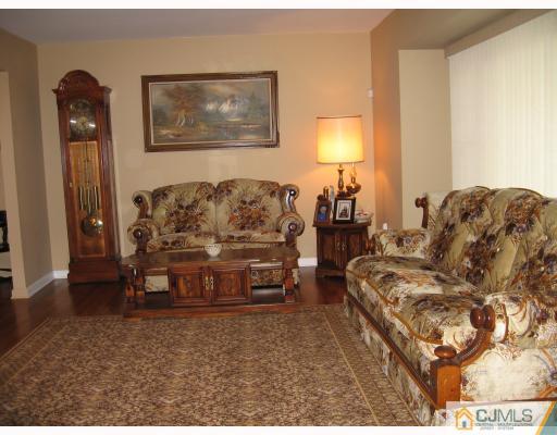 16 Surrey Road Somerset, NJ 08873 - Photo 2 of 8 a living room with furniture and a lamp
