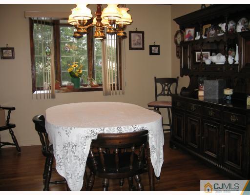 16 Surrey Road Somerset, NJ 08873 - Photo 3 of 8 a view of a dining room with furniture and chandelier