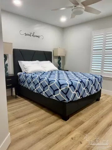 a bedroom with a large bed and a large window