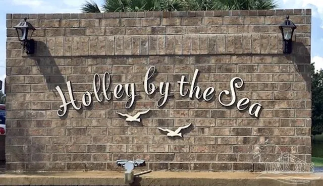 a view of a yard with wooden fence