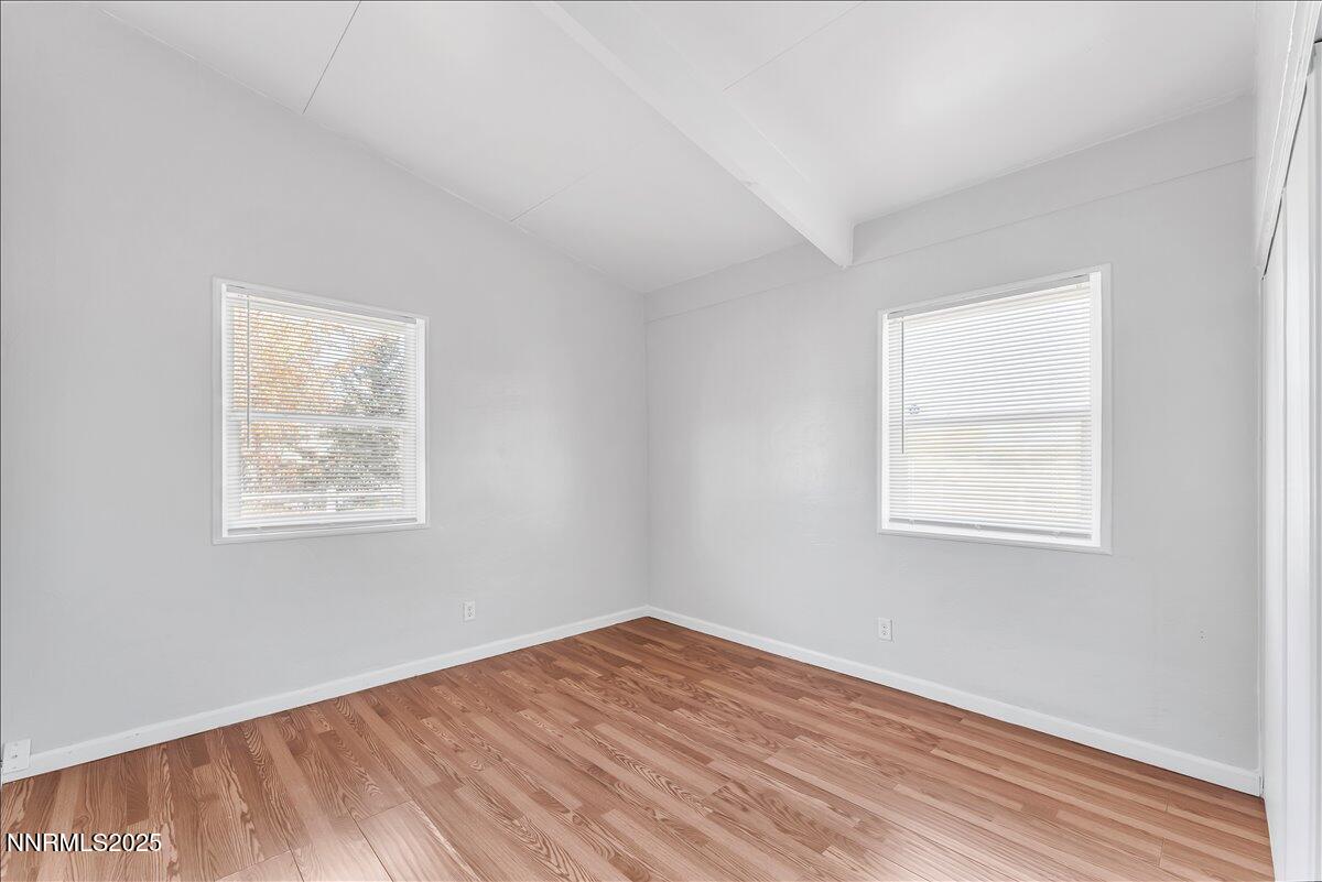 12123 Andes Street Reno, NV 89506 - Photo 11 of 24 a view of an empty room with wooden floor and a window