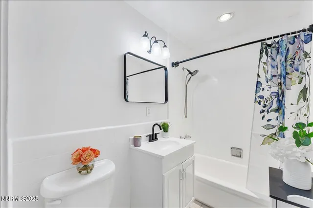 a bathroom with a shower curtain and a sink