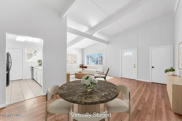 a dining room with furniture and wooden floor