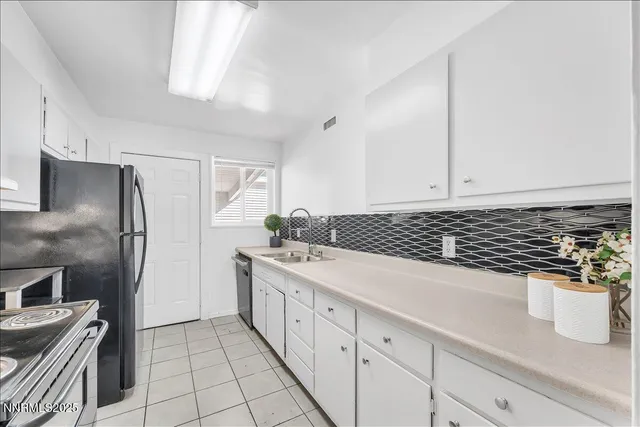 a kitchen with a sink and stainless steel appliances