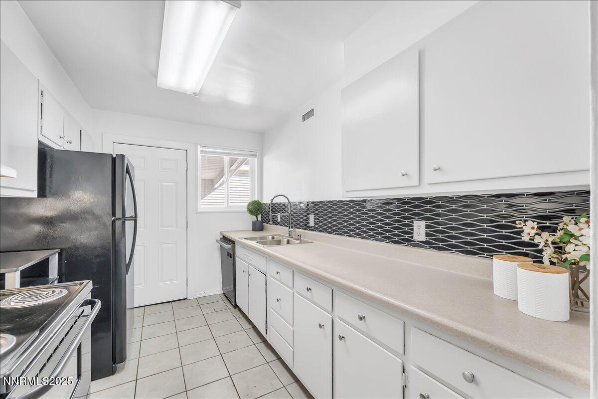 12123 Andes Street Reno, NV 89506 - Photo 6 of 24 a kitchen with a sink and stainless steel appliances