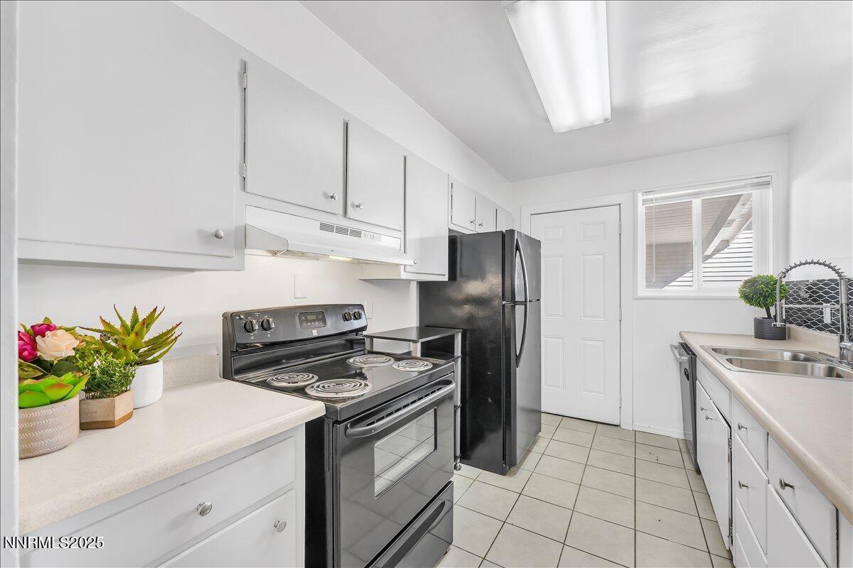12123 Andes Street Reno, NV 89506 - Photo 7 of 24 a kitchen with stainless steel appliances a sink a stove a refrigerator a counter space and cabinets
