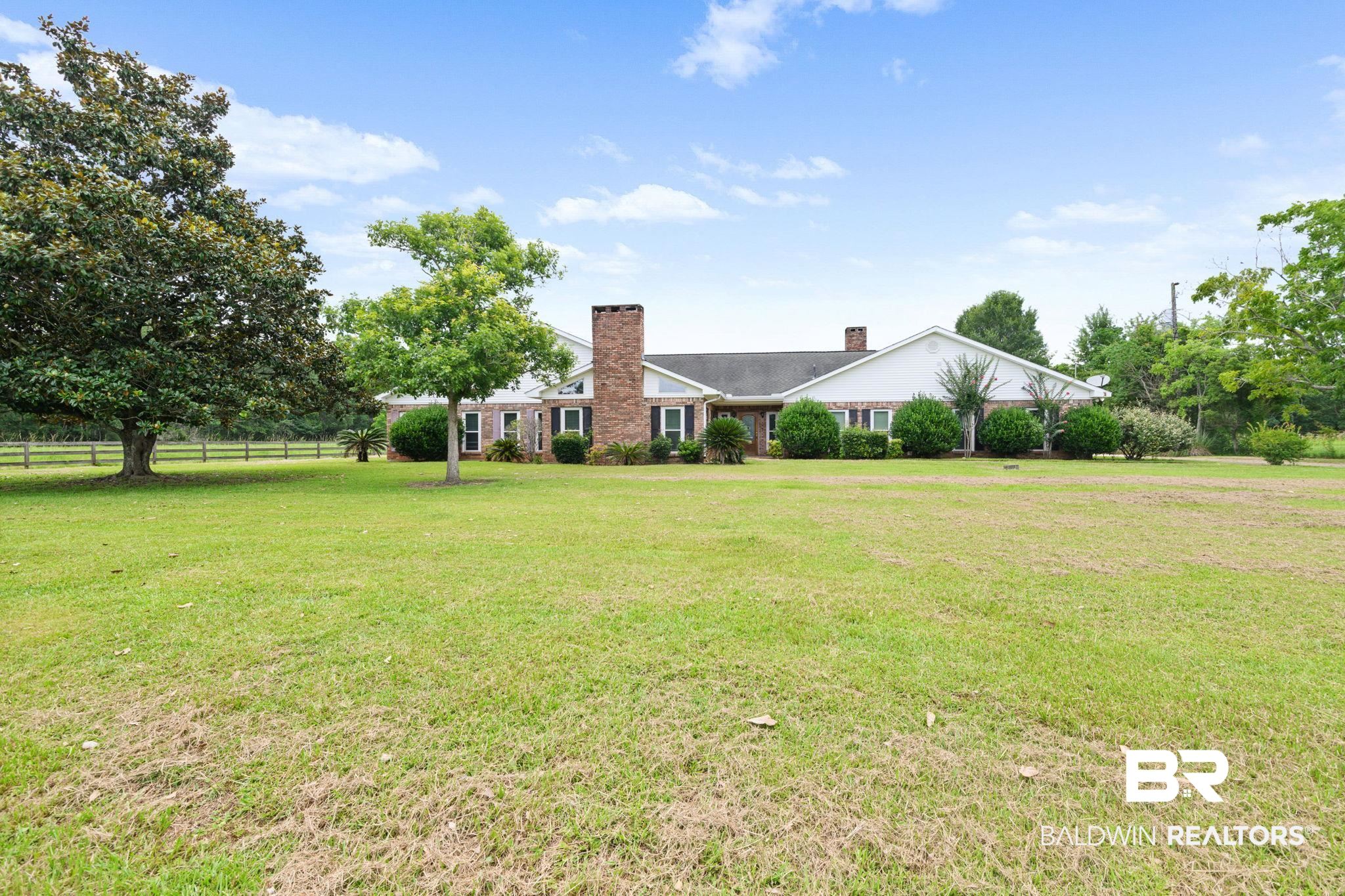 7540 2 Mile Road Irvington, AL 36544 - Photo 82 of 82 Expansive green lawn surrounds a brick and siding residence