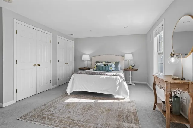 a bedroom with a bed and a mirror