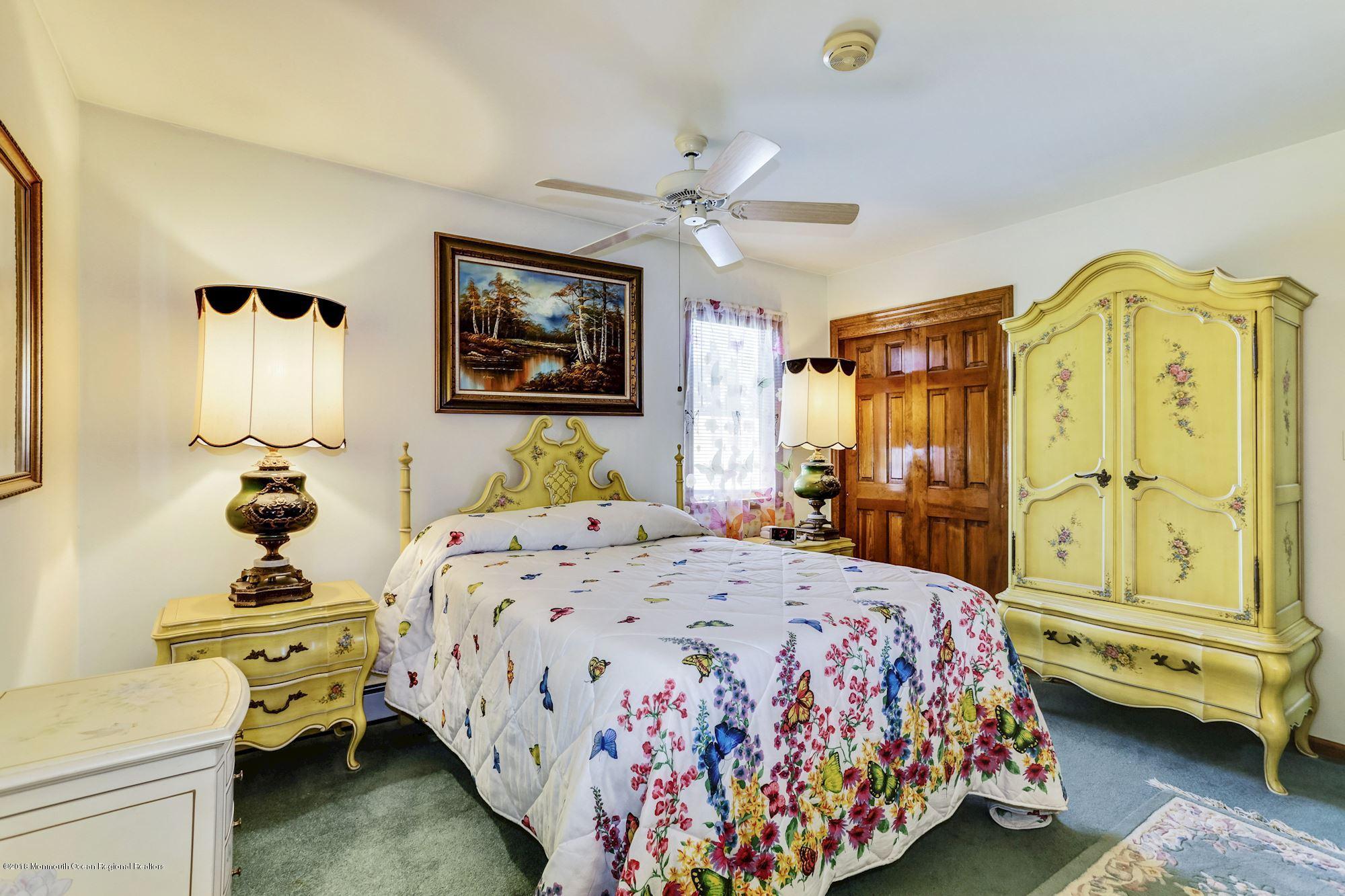 9 Kenmore Road Freehold, NJ 07728 - Photo 14 of 25 a bedroom with a bed and wooden floor