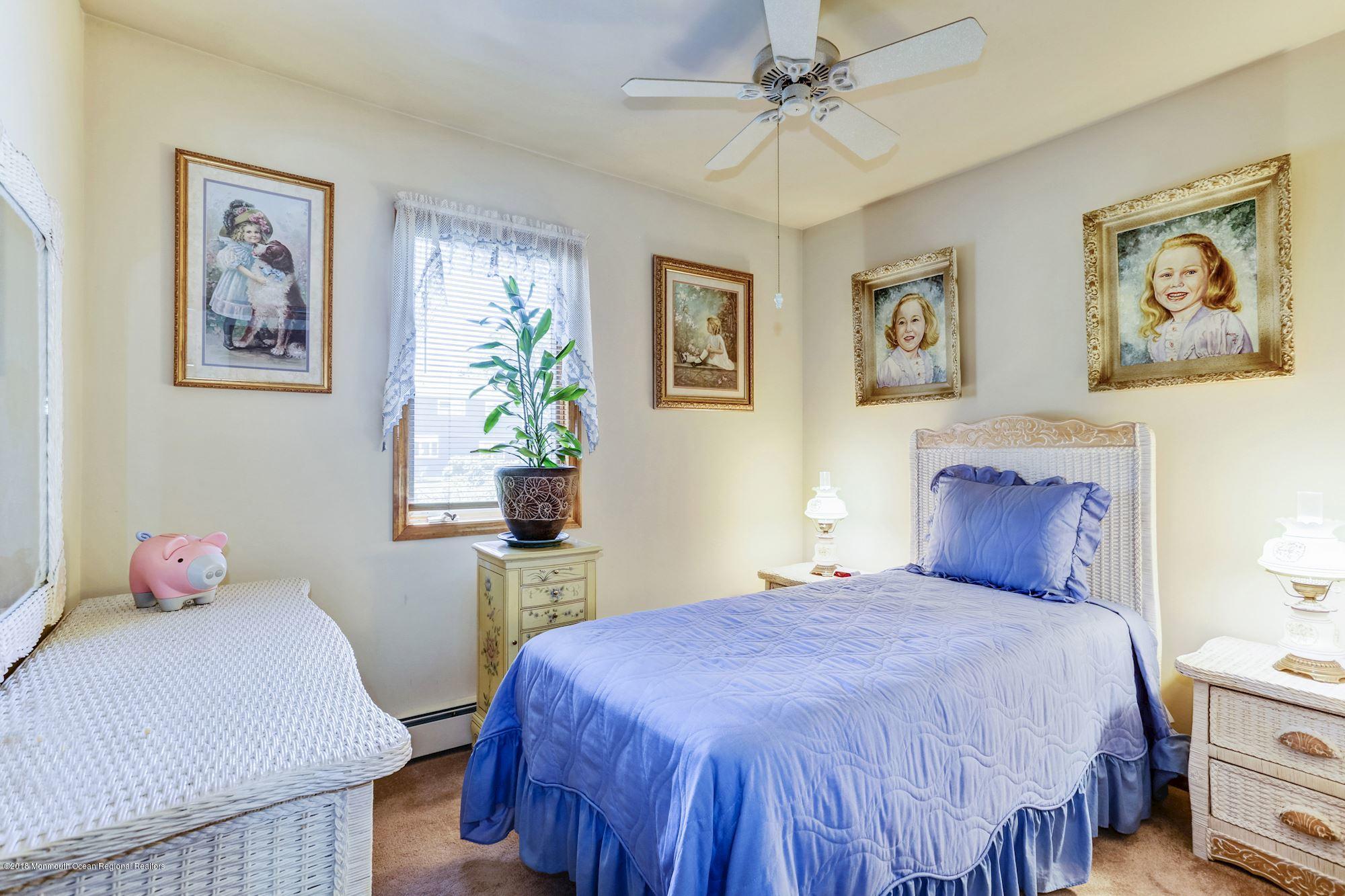 9 Kenmore Road Freehold, NJ 07728 - Photo 16 of 25 a bedroom with a bed and a table