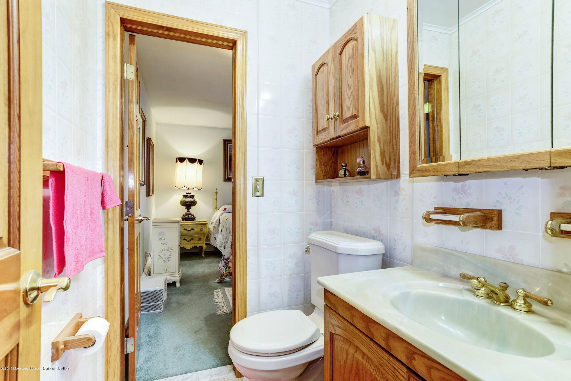 9 Kenmore Road Freehold, NJ 07728 - Photo 19 of 25 a bathroom with a sink a toilet and shower