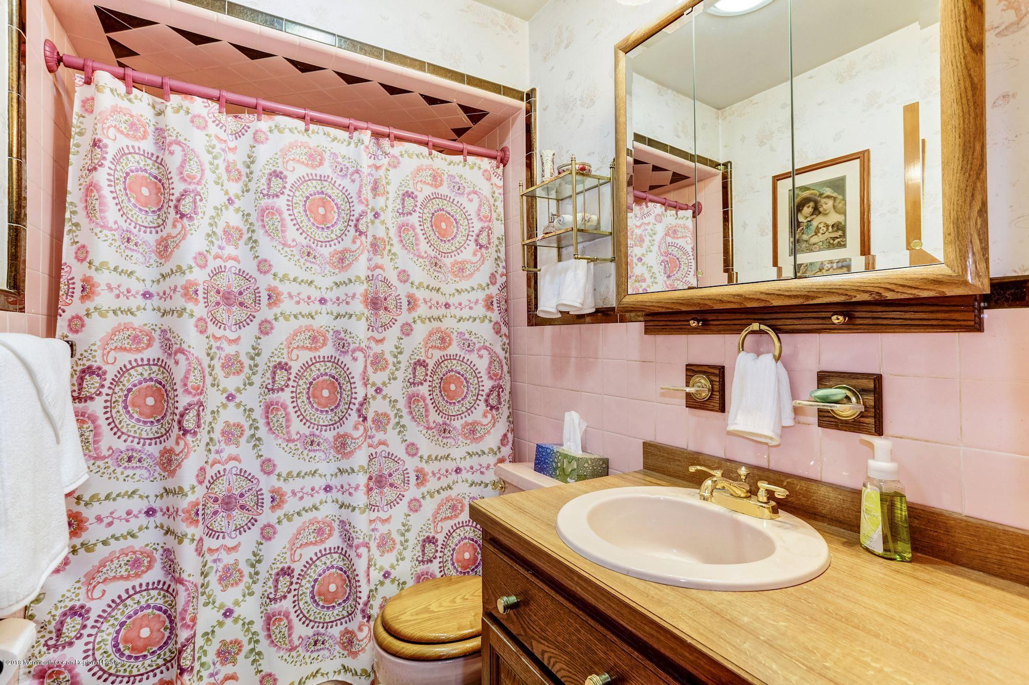 9 Kenmore Road Freehold, NJ 07728 - Photo 20 of 25 a bathroom with a sink and a mirror