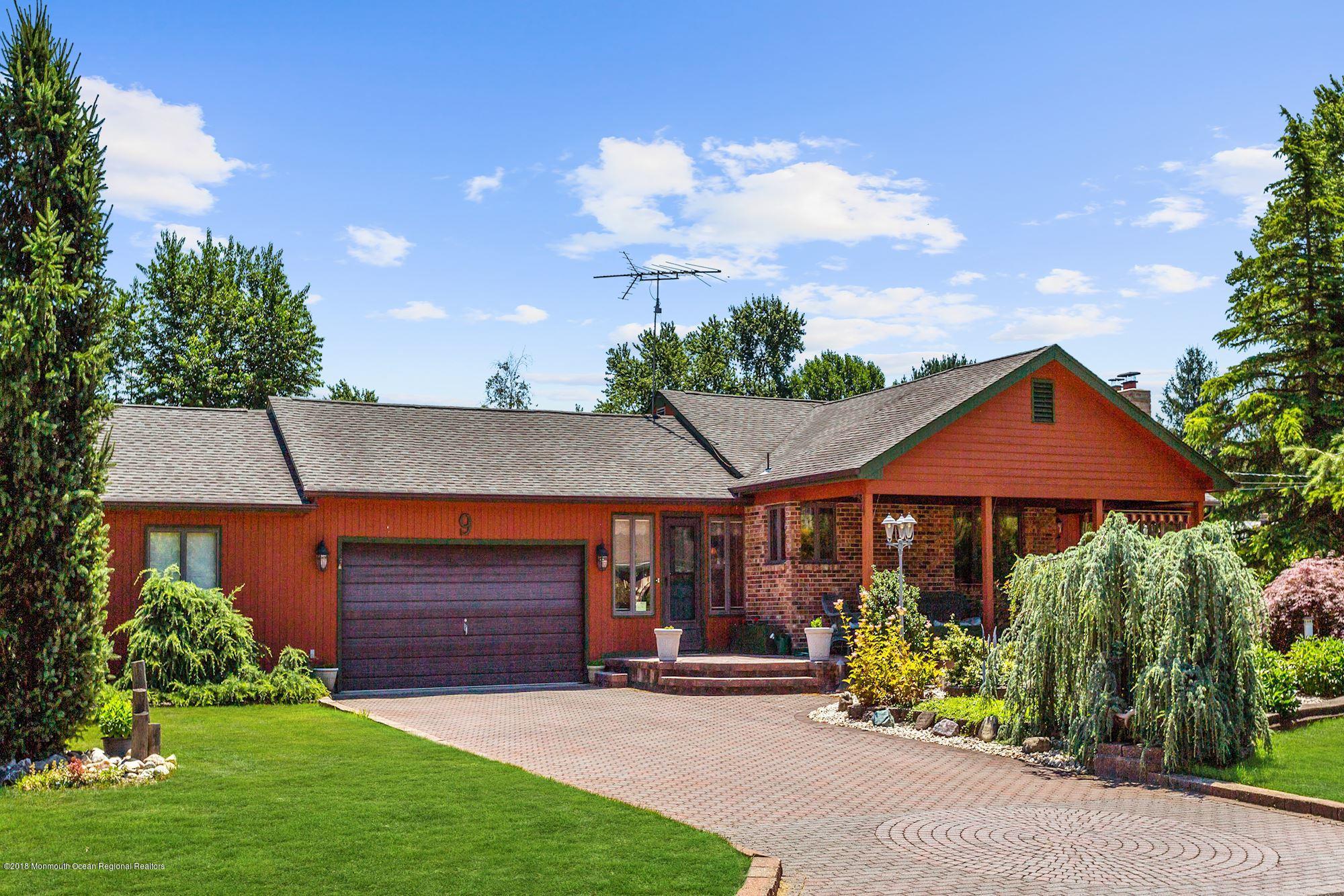 9 Kenmore Road Freehold, NJ 07728 - Photo 2 of 25 a front view of a house with a yard and potted plants
